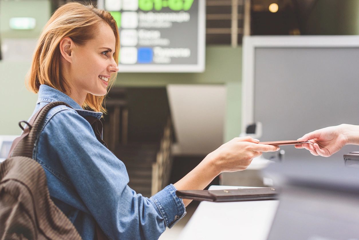 A woman sitting at a table with her laptop.