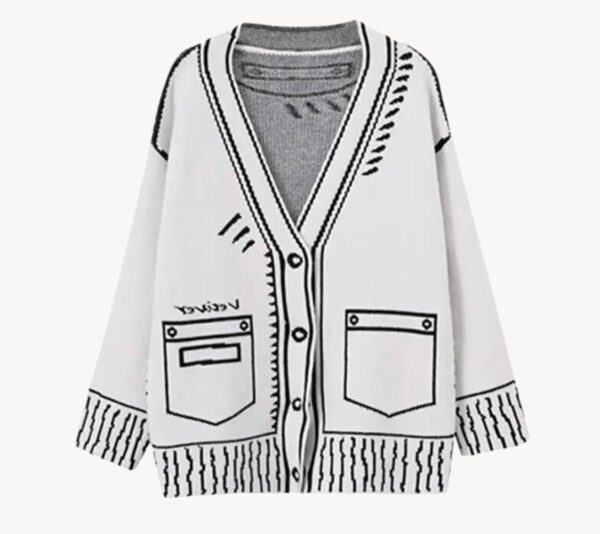 A white cardigan with black and white designs on it.