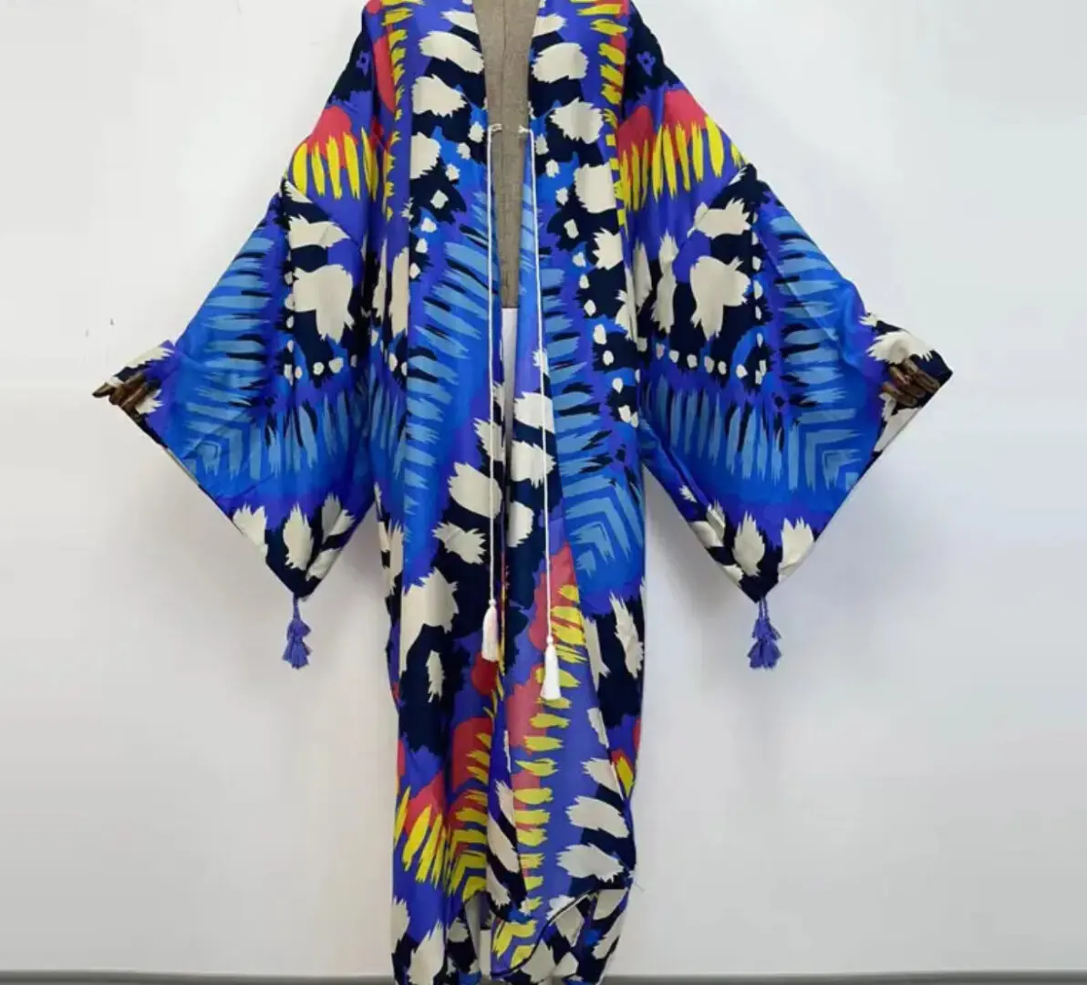 A blue and yellow kimono with colorful feathers.