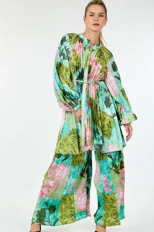 A woman in a floral print robe and pants.