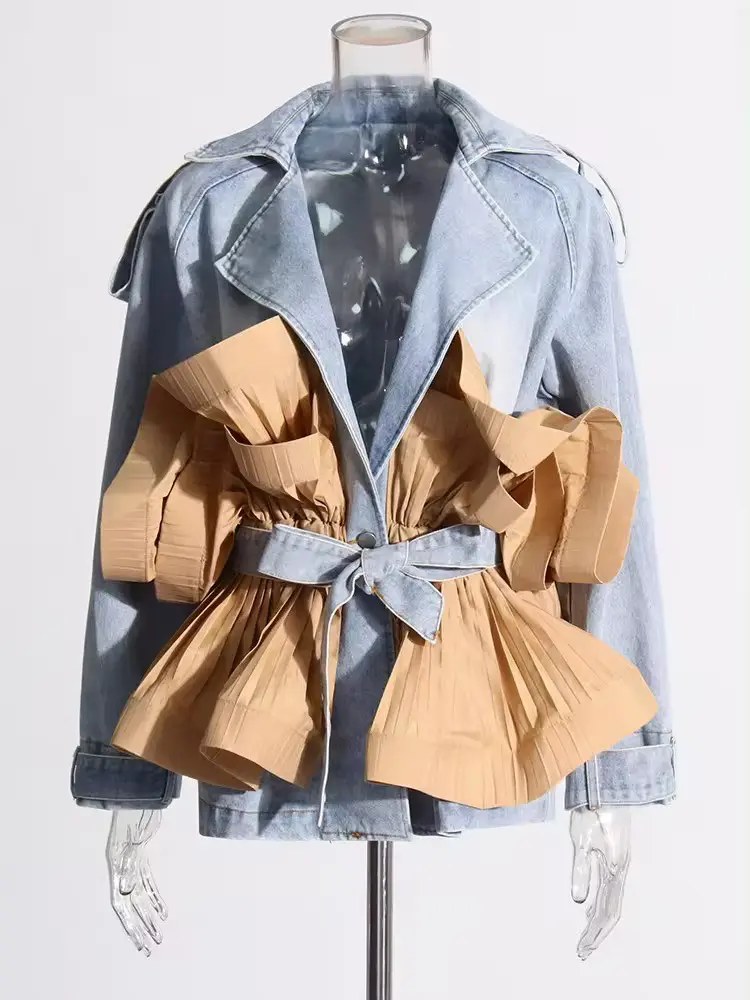 A blue and tan jacket with a bow on the front.